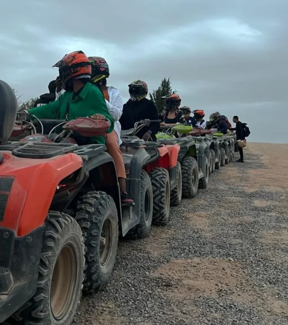 Group of riders on a quad bike Agafay Desert adventure, lined up and ready to explore the scenic desert terrain.