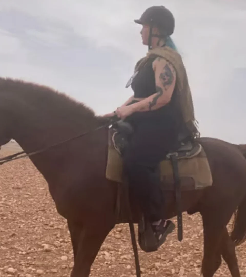 A rider enjoying horse riding in Marrakech, Morocco, exploring the desert landscape on a beautiful brown horse.